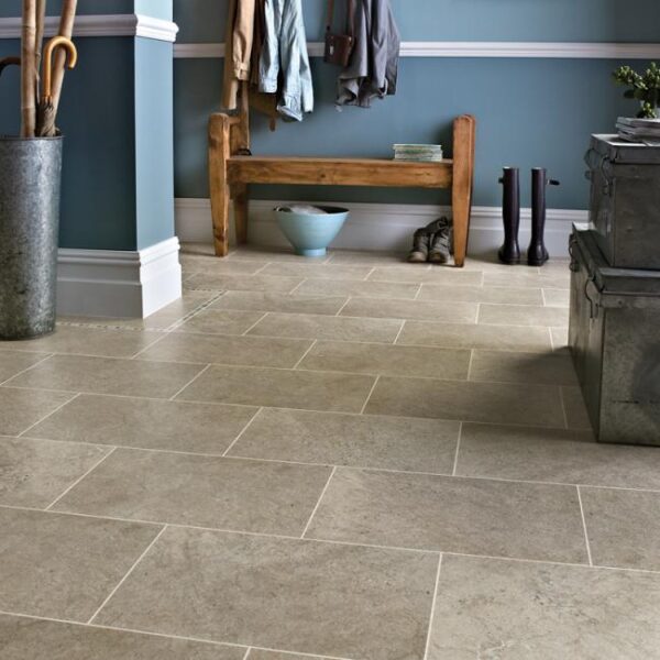 Modern entryway featuring stone tile flooring, wooden bench, and blue walls